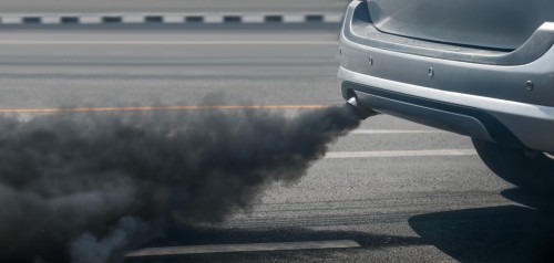 air pollution crisis in city from diesel vehicle exhaust pipe on